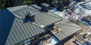 Home with new metal roof installation in the wintertime